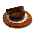 Wooden cake stand with a round wooden base and a brown cake on a white background